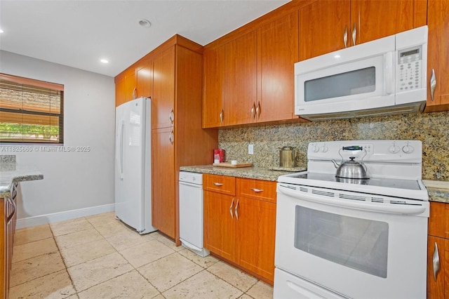3538 Estepona Ave Unit D-2, Doral, FL 33178 - kitchen with white appliances, tasteful backsplash, brown cabinetry, recessed lighting, and light stone counters