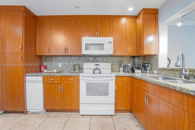 3538 Estepona Ave Unit D-2, Doral, FL 33178 - kitchen with white appliances, decorative backsplash, light stone counters, and brown cabinets