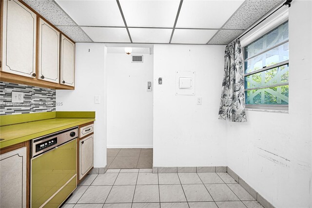 3551 NE 169th St Unit 312, North Miami Beach, FL 33160 - kitchen featuring dishwasher, backsplash, light tile patterned flooring, light countertops, and a paneled ceiling