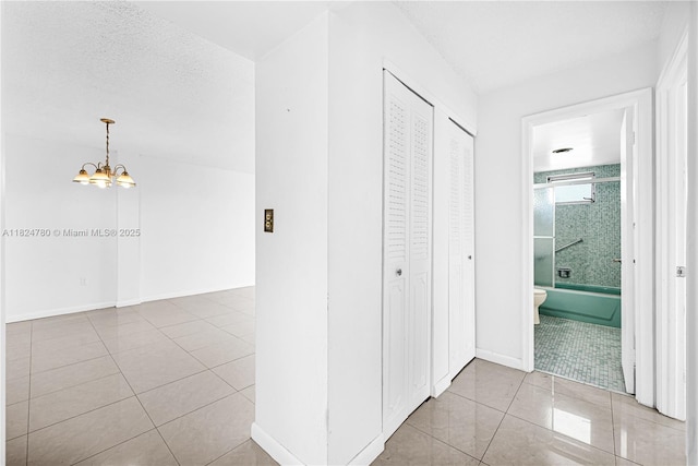 3551 NE 169th St Unit 312, North Miami Beach, FL 33160 - corridor with tile patterned floors and a chandelier