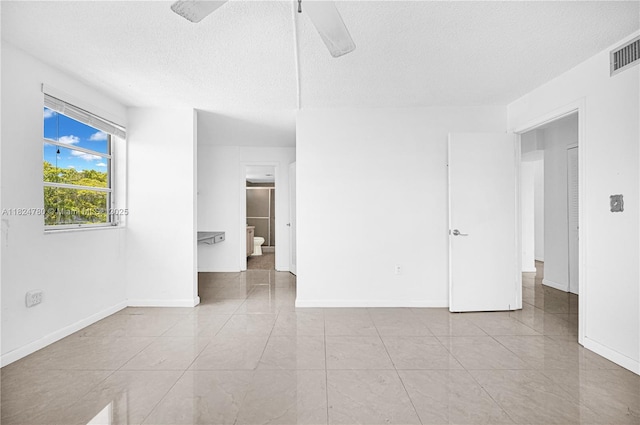 3551 NE 169th St Unit 312, North Miami Beach, FL 33160 - unfurnished room with a ceiling fan, a textured ceiling, and tile patterned flooring