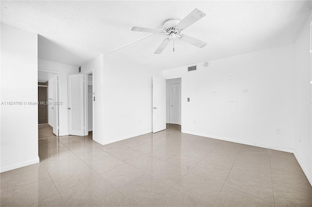 3551 NE 169th St Unit 312, North Miami Beach, FL 33160 - spare room featuring a textured ceiling, a ceiling fan, and tile patterned floors
