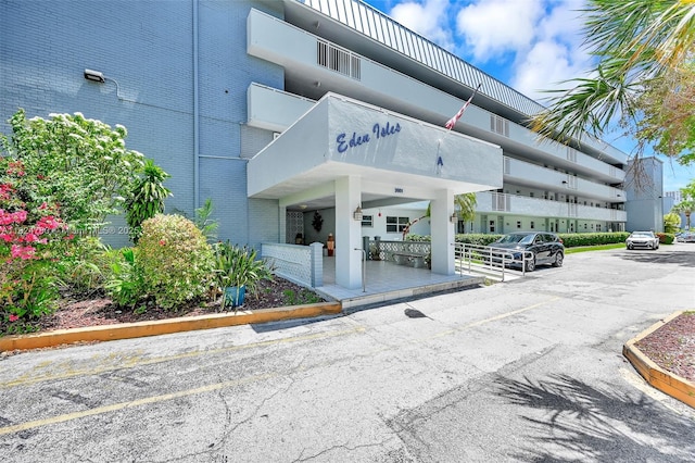 3551 NE 169th St Unit 312, North Miami Beach, FL 33160 - view of building exterior with uncovered parking