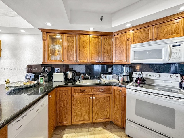 6767 Collins Ave Unit 704, Miami Beach, FL 33141 - kitchen featuring white appliances, brown cabinets, recessed lighting, and decorative backsplash