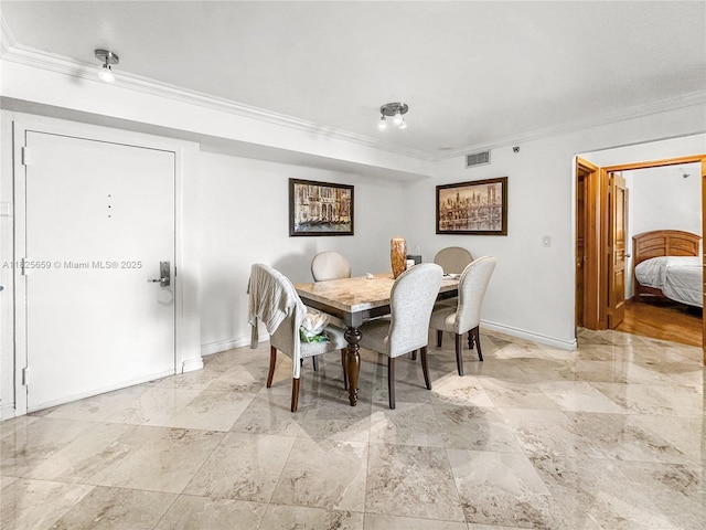 6767 Collins Ave Unit 704, Miami Beach, FL 33141 - dining space featuring ornamental molding