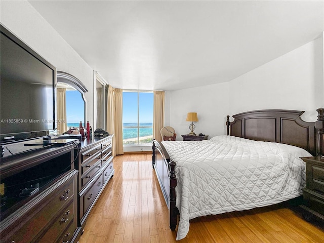 6767 Collins Ave Unit 704, Miami Beach, FL 33141 - bedroom featuring light wood-type flooring, access to exterior, and a water view