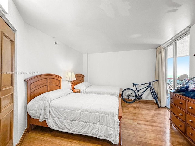 6767 Collins Ave Unit 704, Miami Beach, FL 33141 - bedroom with light wood-type flooring and access to outside