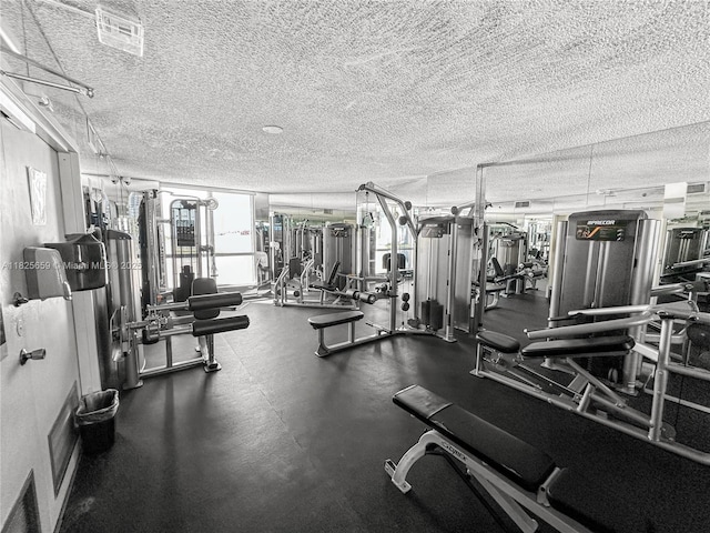 6767 Collins Ave Unit 704, Miami Beach, FL 33141 - gym with a textured ceiling