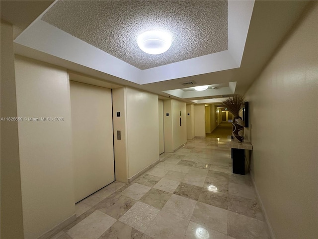 6767 Collins Ave Unit 704, Miami Beach, FL 33141 - hall with a raised ceiling and a textured ceiling