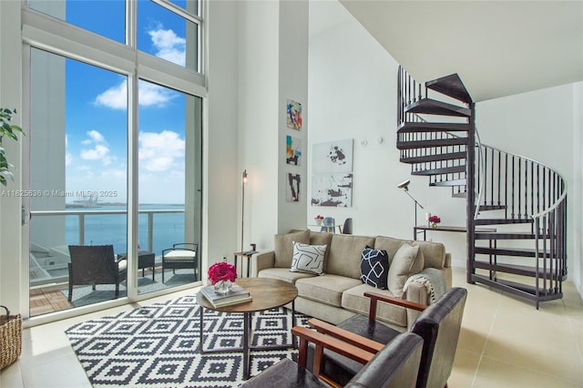 300 S Biscayne Blvd Unit L-1228, Miami, FL 33131 - living area featuring a high ceiling, a water view, tile patterned flooring, stairway, and plenty of natural light