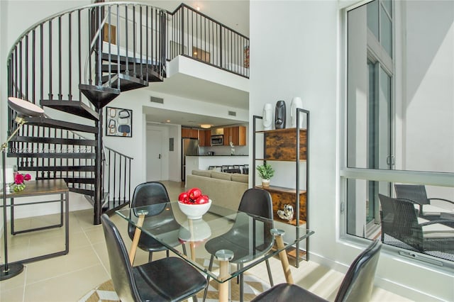 300 S Biscayne Blvd Unit L-1228, Miami, FL 33131 - dining space featuring stairs, light tile patterned flooring, and a high ceiling