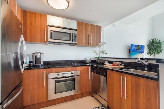 300 S Biscayne Blvd Unit L-1228, Miami, FL 33131 - kitchen featuring appliances with stainless steel finishes, brown cabinetry, dark stone countertops, and modern cabinets