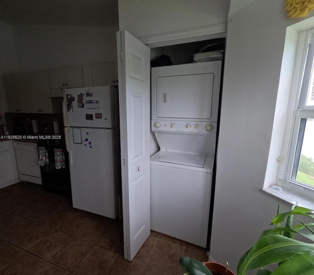 985 NE 34th Ave Unit 203, Homestead, FL 33033 - washroom with estacked washer and dryer and dark tile patterned floors