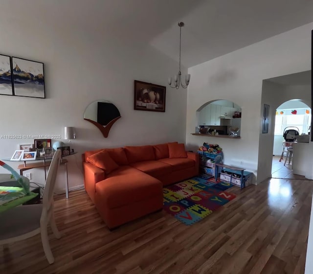 985 NE 34th Ave Unit 203, Homestead, FL 33033 - living room with wood finished floors, a chandelier, and arched walkways