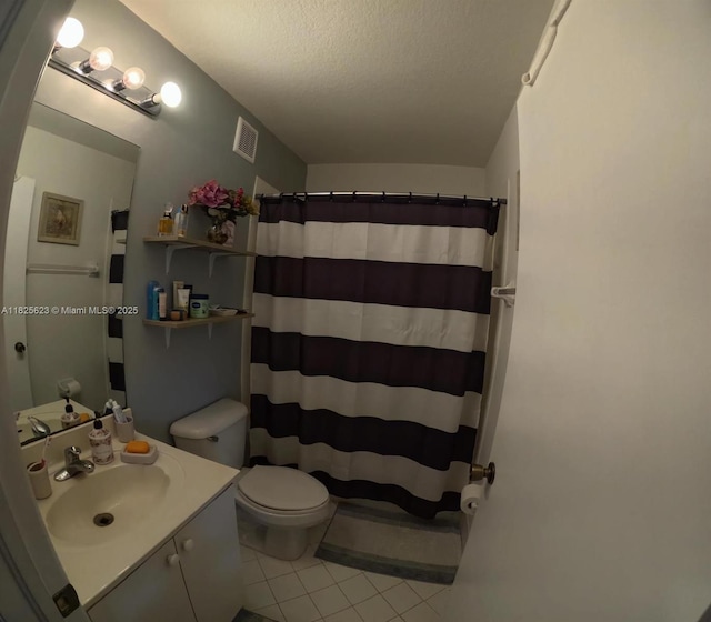 985 NE 34th Ave Unit 203, Homestead, FL 33033 - bathroom with tile patterned floors, vanity, a textured ceiling, and a shower with shower curtain