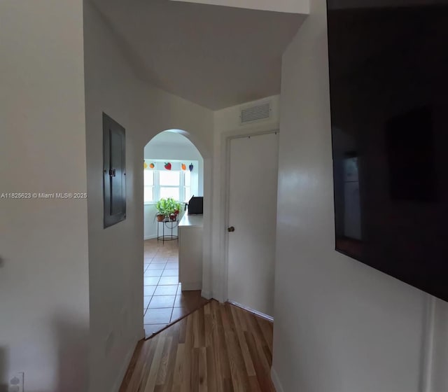 985 NE 34th Ave Unit 203, Homestead, FL 33033 - corridor with arched walkways, electric panel, and wood finished floors