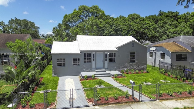 1051 NW 63rd St, Miami, FL 33150 - view of front of house with a gate, a fenced front yard, and stucco siding