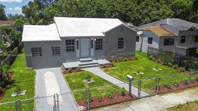 1051 NW 63rd St, Miami, FL 33150 - view of front facade featuring a gate, stucco siding, and a fenced front yard