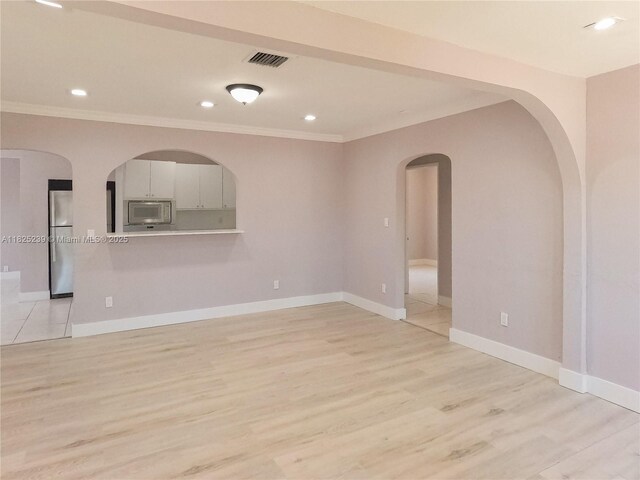 1051 NW 63rd St, Miami, FL 33150 - unfurnished room with crown molding, arched walkways, light wood-style floors, and recessed lighting