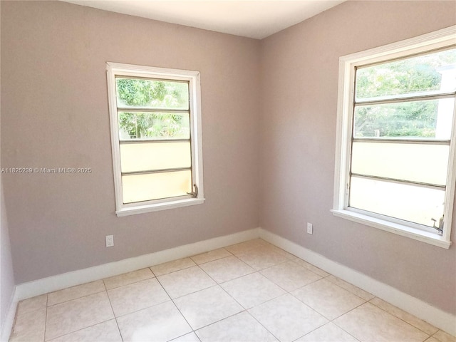 1051 NW 63rd St, Miami, FL 33150 - empty room with plenty of natural light and light tile patterned floors