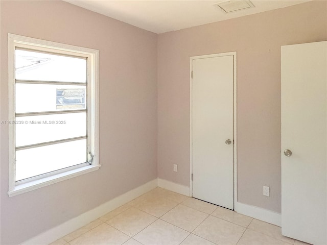1051 NW 63rd St, Miami, FL 33150 - unfurnished room featuring light tile patterned floors and baseboards