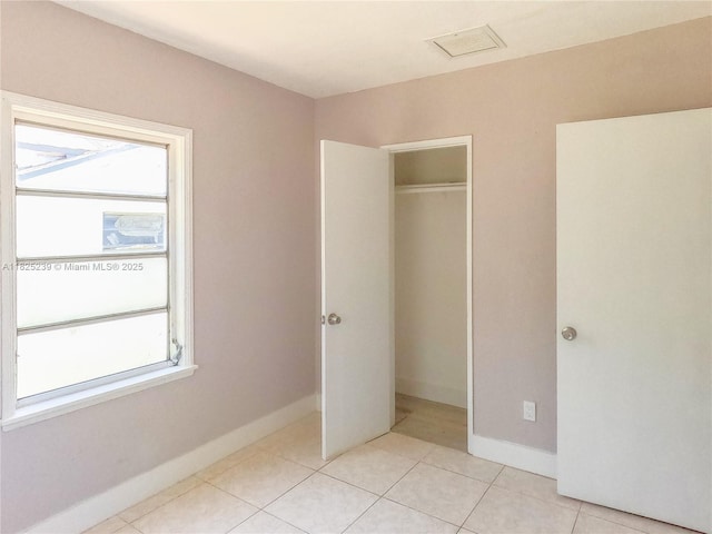 1051 NW 63rd St, Miami, FL 33150 - unfurnished bedroom featuring light tile patterned flooring and a closet
