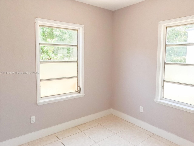 1051 NW 63rd St, Miami, FL 33150 - spare room with healthy amount of natural light and light tile patterned floors