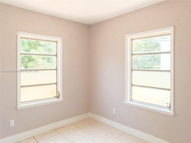 1051 NW 63rd St, Miami, FL 33150 - unfurnished room featuring healthy amount of natural light and light tile patterned flooring