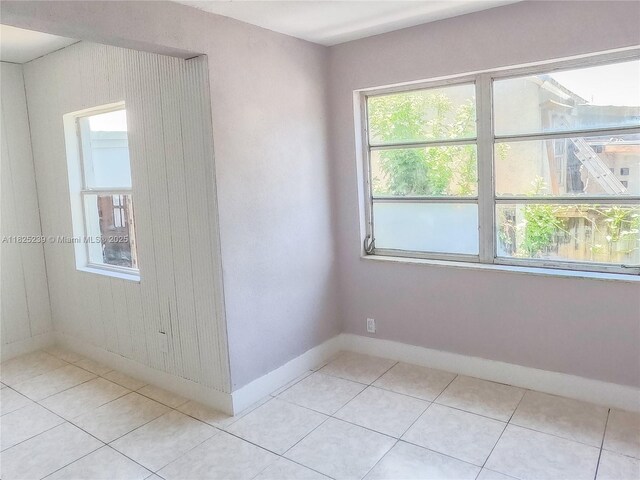 1051 NW 63rd St, Miami, FL 33150 - unfurnished room with healthy amount of natural light and light tile patterned flooring