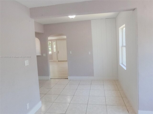 1051 NW 63rd St, Miami, FL 33150 - empty room featuring arched walkways and light tile patterned flooring