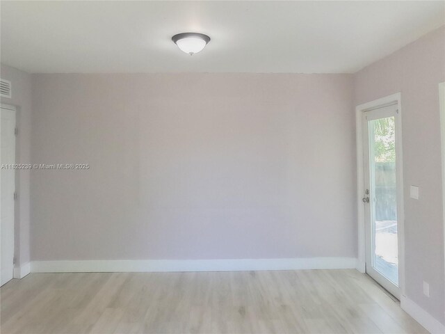 1051 NW 63rd St, Miami, FL 33150 - empty room with light wood finished floors and baseboards
