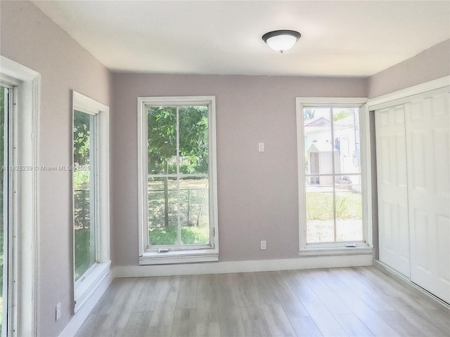1051 NW 63rd St, Miami, FL 33150 - unfurnished dining area featuring light wood finished floors and baseboards