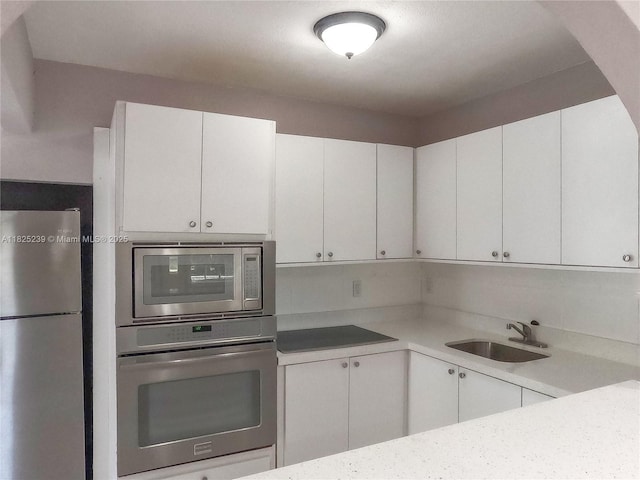 1051 NW 63rd St, Miami, FL 33150 - kitchen featuring stainless steel appliances, light countertops, and white cabinetry