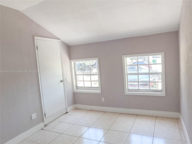 1051 NW 63rd St, Miami, FL 33150 - spare room with vaulted ceiling and light tile patterned flooring