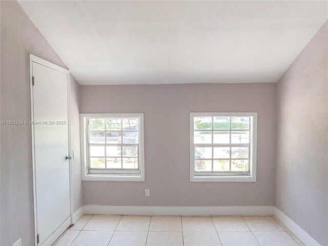 1051 NW 63rd St, Miami, FL 33150 - empty room featuring healthy amount of natural light and light tile patterned floors