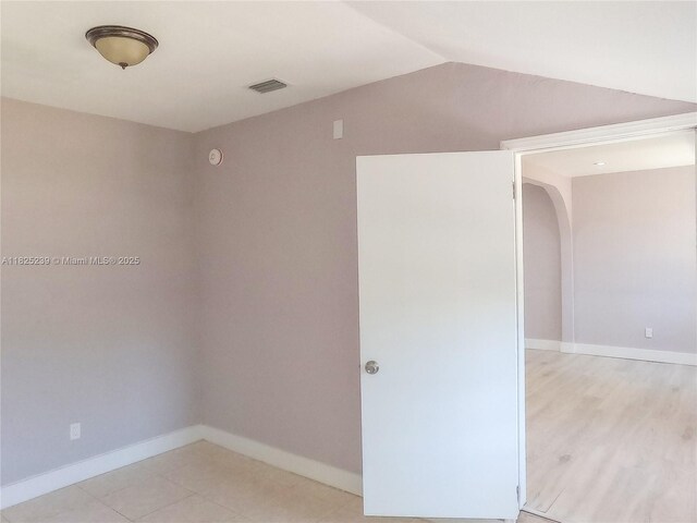1051 NW 63rd St, Miami, FL 33150 - empty room with vaulted ceiling and arched walkways