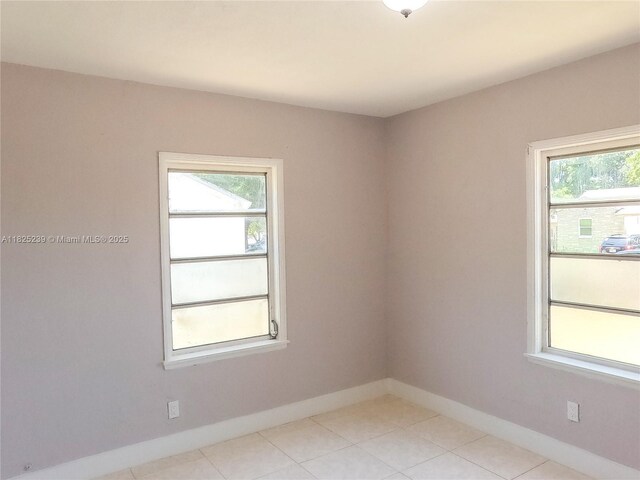 1051 NW 63rd St, Miami, FL 33150 - empty room with baseboards and light tile patterned floors