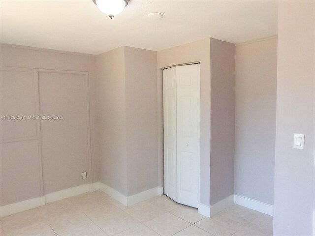 1051 NW 63rd St, Miami, FL 33150 - unfurnished bedroom with a closet and light tile patterned flooring