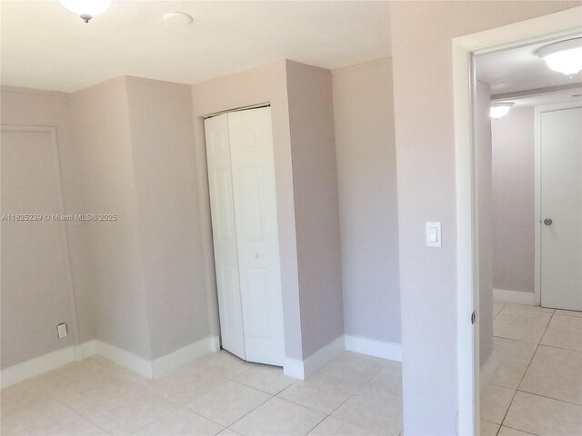 1051 NW 63rd St, Miami, FL 33150 - unfurnished bedroom with a closet and light tile patterned floors