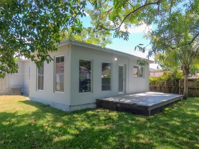 1051 NW 63rd St, Miami, FL 33150 - rear view of house featuring a deck and stucco siding