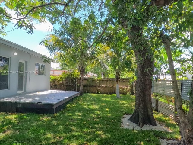 1051 NW 63rd St, Miami, FL 33150 - fenced backyard with a wooden deck
