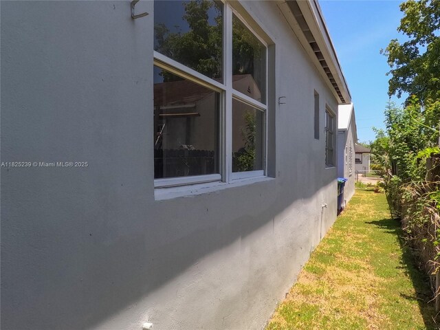 1051 NW 63rd St, Miami, FL 33150 - view of property exterior with stucco siding and a yard