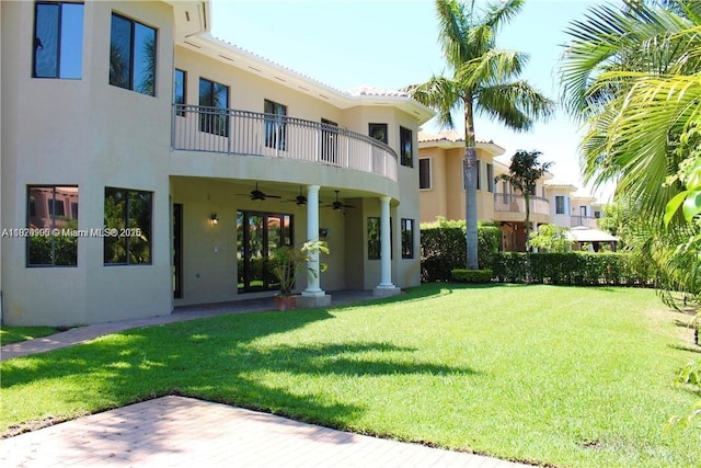 19383 SW 79th Ave, Cutler Bay, FL 33157 - rear view of property with stucco siding, a balcony, ceiling fan, and a lawn