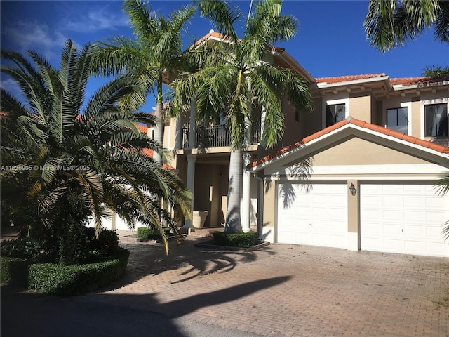 19383 SW 79th Ave, Cutler Bay, FL 33157 - view of front facade featuring stucco siding, decorative driveway, a balcony, and a tiled roof