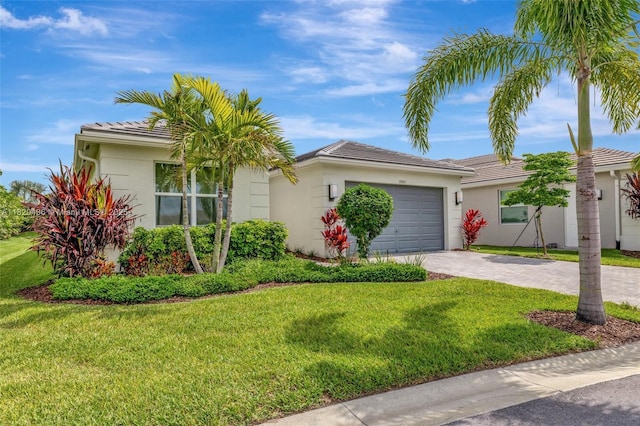 13307 SW Green Delta Rd, Port St Lucie, FL 34987 - ranch-style home with stucco siding, decorative driveway, an attached garage, and a front yard