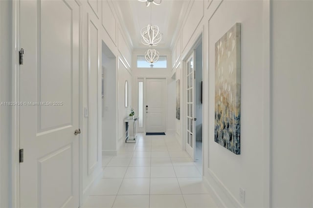 13307 SW Green Delta Rd, Port St Lucie, FL 34987 - entrance foyer with a chandelier and light tile patterned floors