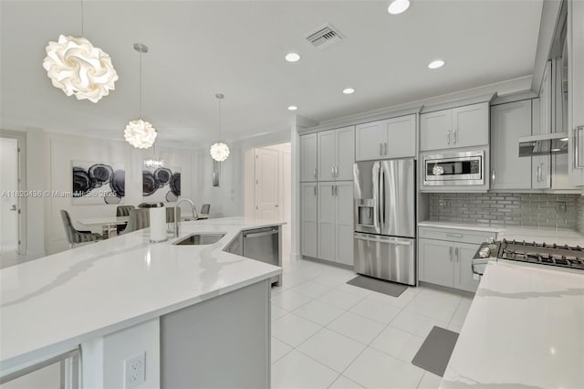 13307 SW Green Delta Rd, Port St Lucie, FL 34987 - kitchen with appliances with stainless steel finishes, gray cabinets, light tile patterned floors, decorative backsplash, and recessed lighting