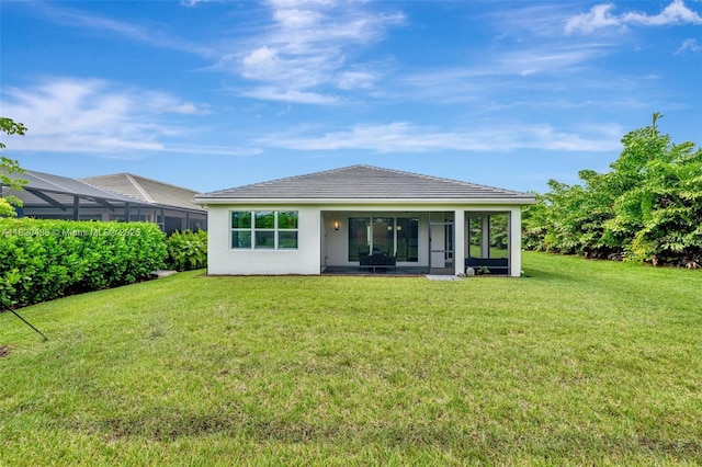 13307 SW Green Delta Rd, Port St Lucie, FL 34987 - rear view of house with a yard, a sunroom, stucco siding, and a tile roof