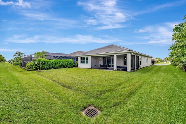 13307 SW Green Delta Rd, Port St Lucie, FL 34987 - back of house with a lawn, a sunroom, and stucco siding