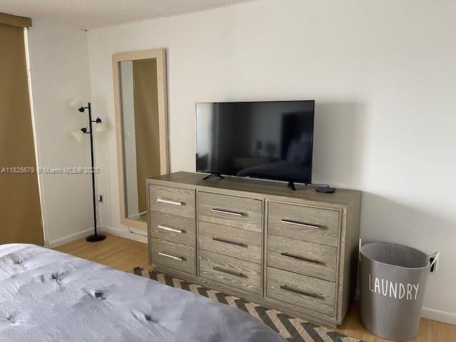 1351 NE Miami Gardens Dr Unit 1014E, Miami, FL 33179 - bedroom with wood finished floors and baseboards
